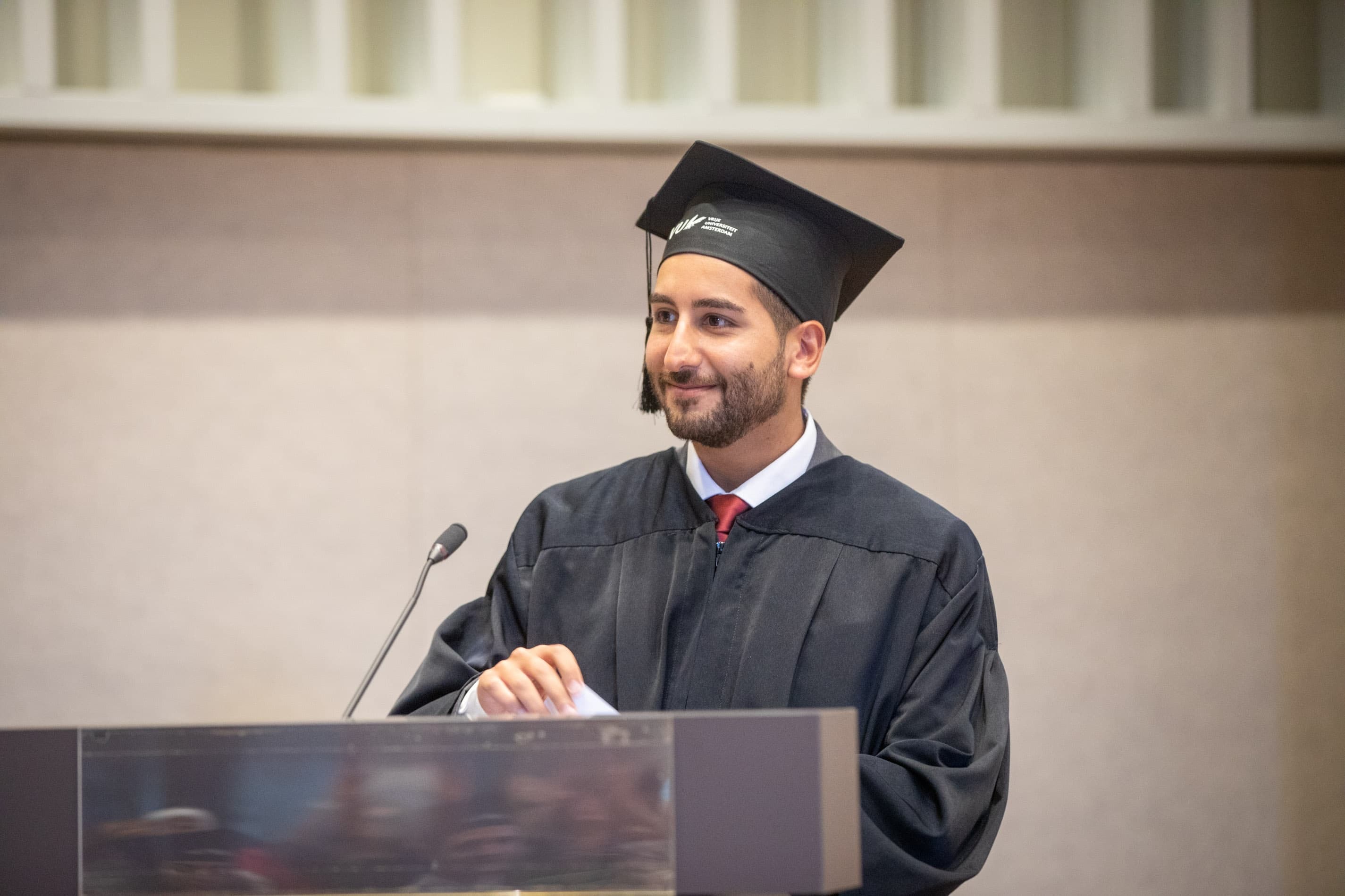 Bandar Shanneik delivering an address at a lectern